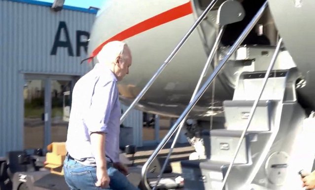 This screen shot courtesy of WikiLeaks X page shows Wikileaks founder Julian Assange walking to board a plane from London Stansted Airport on June 24, 2024. Julian Assange “is free” and has been released from a high-security London prison where he was held for five years, his Wikileaks organisation said June 24, after reaching a US plea deal The 52-year-old Australian was taken Monday, June 24, from Belmarsh prison to London's Stansted airport, a Wikileaks statement said, from where he boarded a flight to an unnamed destination. (Photo by WikiLeaks/AFP Photo)