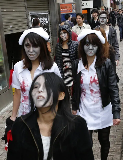 People, dressed as zombies, participate in the Roppongi Zombie Walk in Tokyo March 31, 2013. (Photo by Yuya Shino/Reuters)