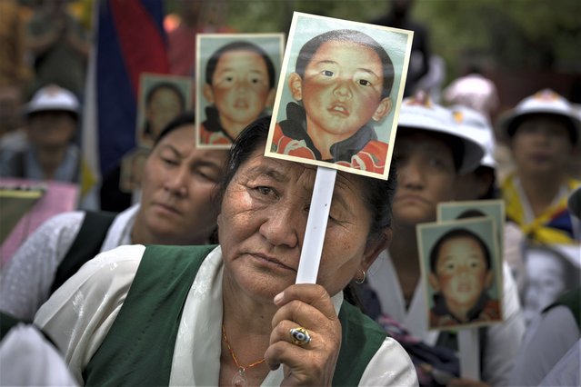 Members of the Tibetan Women's Association hold portraits of the 11th Panchen Lama, Gendhun Choekyi Nyima, as they participate in a protest demanding his release, in New Delhi, India, Wednesday, May, 17, 2023. The boy lama, who is the second highest religious leader in Tibetan Buddhist hierarchy, went missing shortly after his recognition by the Dalai Lama in 1995 and has not been seen since. (Photo by Altaf Qadri/AP Photo)