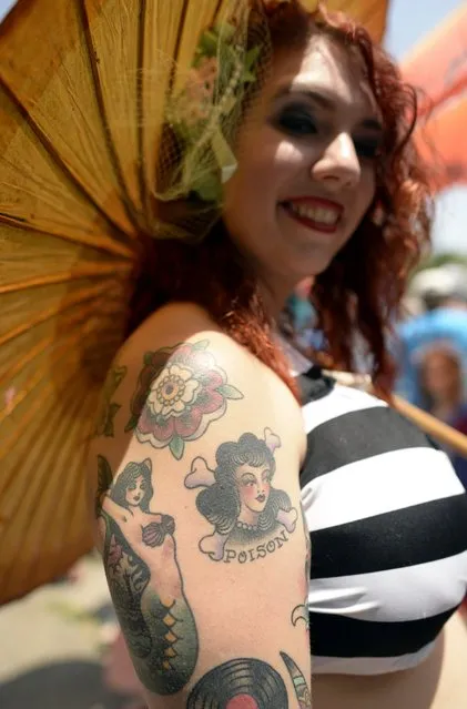 A parade participant arrives in costume for the 31st Annual Mermaid Parade at New York's Coney Island on June 22, 2103. Over 700,00 people are exptected to turn out for the  scantily clad parade.       AFP PHOTO / TIMOTHY CLARY        (Photo credit should read TIMOTHY CLARY/AFP/Getty Images)