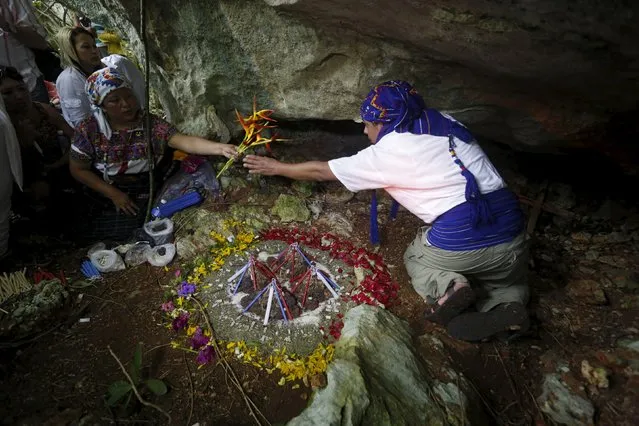 Mayan spiritual leaders Juana Justa Yax Tale, (L), and her husband Pablo Pedro Yax, from Guatemala, lead a ceremony in honor of the Mayan ancestors in Madruga, Cuba, December 8, 2015. (Photo by Reuters/Stringer)