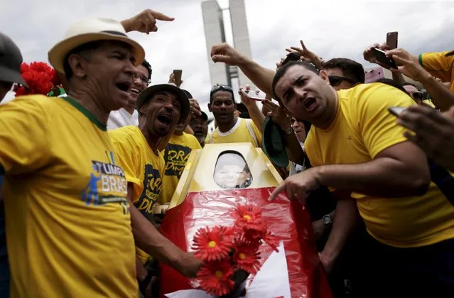 Demonstrators carry a coffin with the Worker's Party flag and an image depicting Brazil's President Dilma Rousseff during a protest calling for the impeachment of Rousseff in front of the National Congress in Brasilia, Brazil, December 13, 2015. (Photo by Ueslei Marcelino/Reuters)