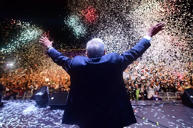 Newly elected Mexico' s President Andres Manuel Lopez Obrador (C), running for “Juntos haremos historia” party, cheers his supporters at the Zocalo Square after winning general elections, in Mexico City, on July 1, 2018. (Photo by Pedro Pardo/AFP Photo)