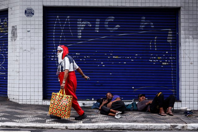 A man dressed as Santa Claus, who identifies as “Sultan Das Matas”, walks, in Sao Paulo, Brazil on December 9, 2024. (Photo by Amanda Perobelli/Reuters)