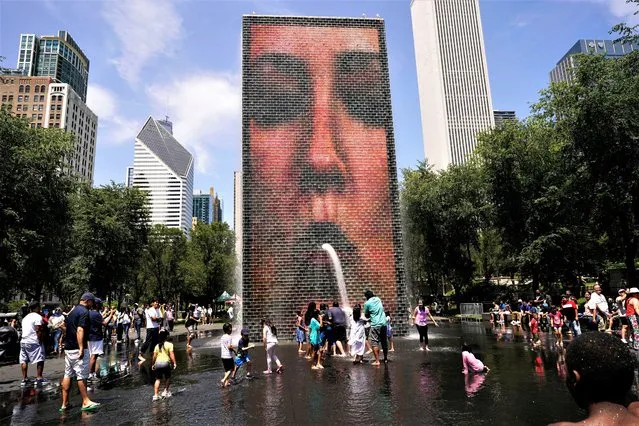 People cool off at the Crown Fountain at Millennium Park in Chicago, Monday, July 3, 2023. (Photo by Nam Y. Huh/AP Photo)