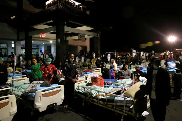 Patients are seen outside a hospital following a strong earthquake on nearby Lombok island, at a government hospital near Denpasar, Bali, Indonesia August 5, 2018. (Photo by Johannes P. Christo/Reuters)
