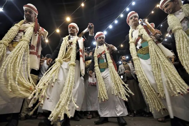 Yemeni grooms dance during a mass wedding ceremony in Sana'a, Yemen, 18 June 2023. A philanthropist has funded the mass wedding for 34 couples. Mass weddings in Yemen are mostly funded and organized by charity organizations and philanthropists to make it easier for people, who couldn’t otherwise afford one, due to high dowries and the high ceremony costs amid a deteriorating economy in war-ridden Yemen. Upon strict Muslim traditions practiced in Yemen, men and women have their celebrations separately. (Photo by Yahya Arhab/EPA/EFE)