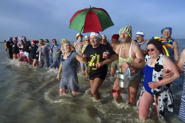 People wearing costumes participate in a traditional New Year's Day swim in Dunkirk, northern France January 1 2016. (Photo by Pascal Rossignol/Reuters)