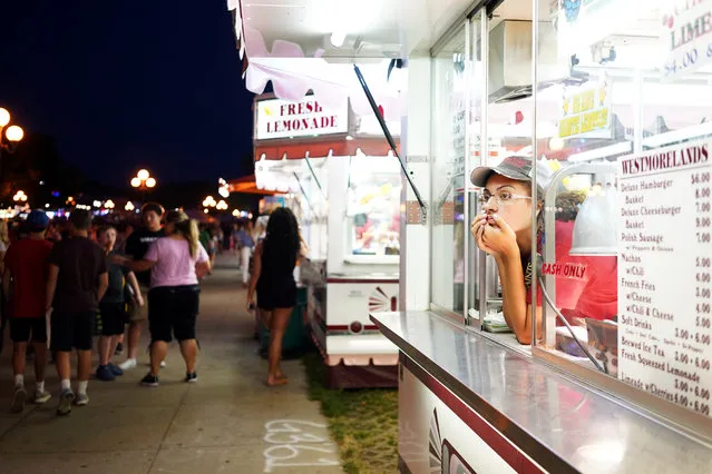 Angie Wilkerson of Des Moines looks out from a food stand at the Iowa State Fair in Des Moines, Iowa, August 9, 2018. (Photo by K.C. McGinnis/Reuters)