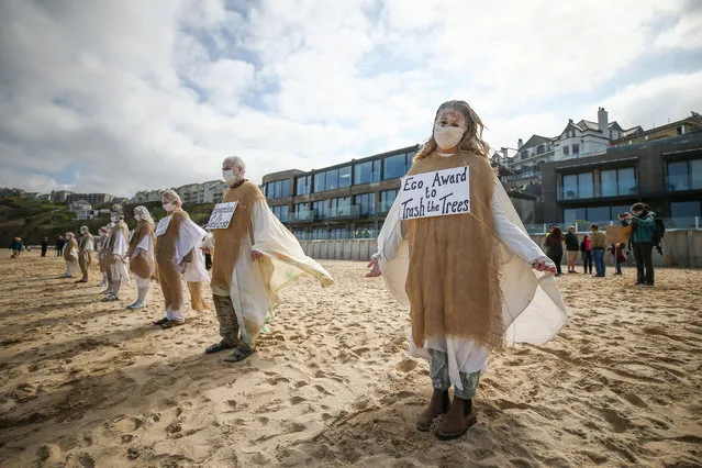 Extinction rebellion protesters on the beach on April 03, 2021 in Carbis Bay, Cornwall, United Kingdom. The protest called for an end to “ecocide” and for the protection of the environment. (Photo by Cameron Smith/Getty Images)