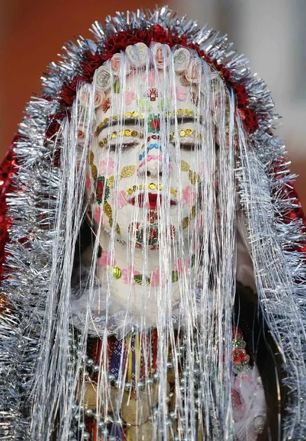 Bulgarian Muslim bride Fikrie Bindzheva poses during her wedding ceremony in the village of Ribnovo, in the Rhodope Mountains, February 15, 2015. (Photo by Stoyan Nenov/Reuters)