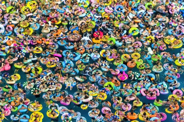 This photo taken on August 12, 2023 shows people cooling off at a water park in Nanjing, in China's eastern Jiangsu province. (Photo by AFP Photo/China Stringer Network)