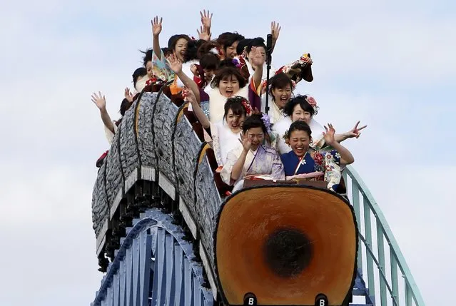 Japanese women wearing kimonos ride a roller coaster during their Coming of Age Day celebration ceremony at an amusement park in Tokyo January 11, 2016. According to a government announcement, more than 1.2 million men and women who were born in 1995 marked the coming of age this year, a decrease of approximately 50,000 from last year. (Photo by Yuya Shino/Reuters)