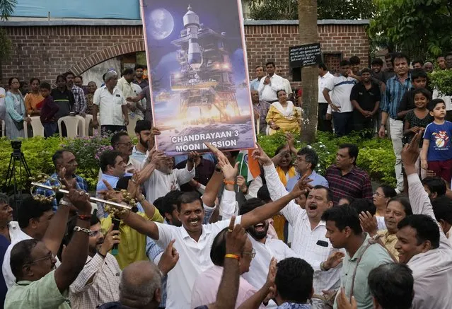 People celebrate as they watch a live telecast of the landing og Chandrayaan-3, or “moon craft” in Sanskrit, in Mumbai, India, Wednesday, August 23, 2023. (Photo by Rajanish Kakade/AP Photo)