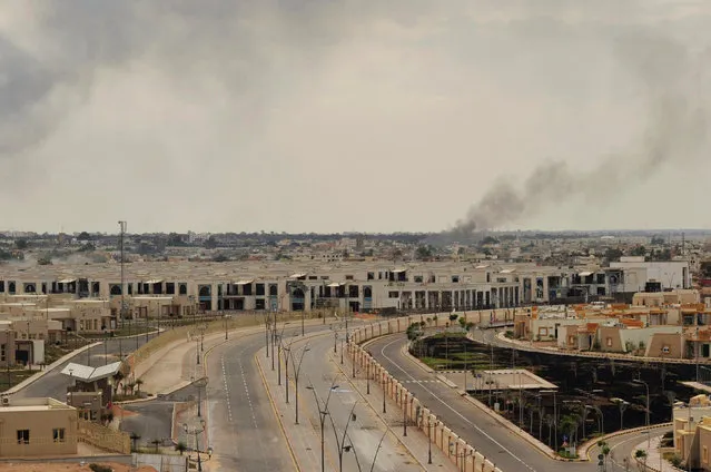Black smoke caused by a large explosion rises inside the city of Sirte, Libya, October 7, 2011. (Photo by Esam Al-Fetori/Reuters)