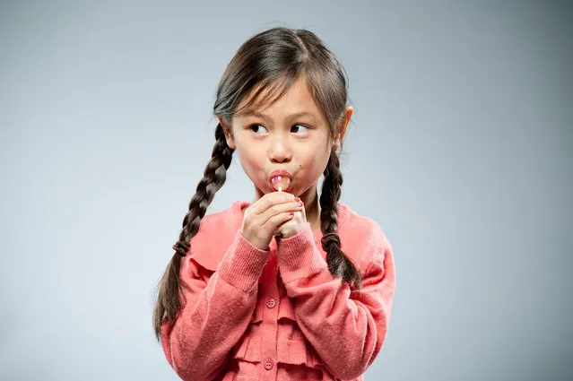 A little girl eating her lollipop. (Photo by Khoa Vu/Getty Images)