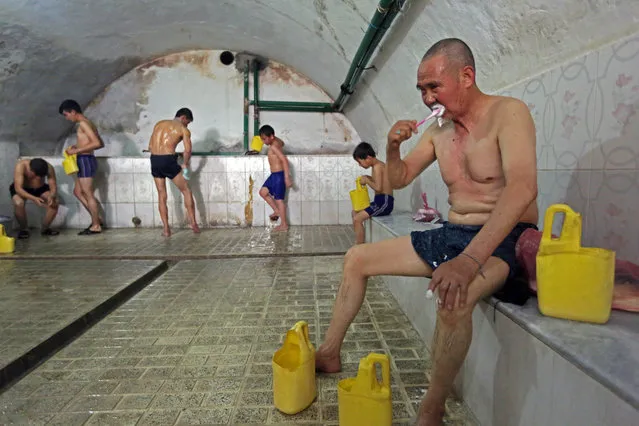 An Afghan man brushes his teeth at a public bath, or “hamam”, in Kabul, Afghanistan, Friday, February 6, 2015. The public baths are a tradition in the country, mostly found in larger cities and used by ordinary citizens including those who had their home boiler facilities damaged during its decade-long war. The use of a hamam bath costs less than a dollar for the public, and a person could pay extra to have a massage. (Photo by Rahmat Gul/AP Photo)