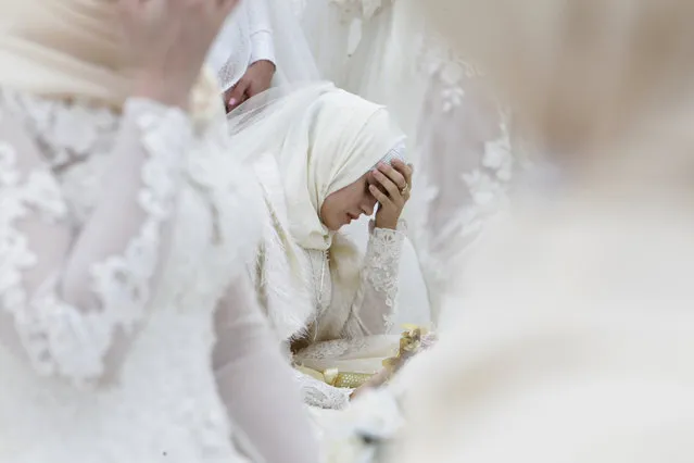 A bride takes part in the simultaneous celebration of 200 weddings to mark the 200th birthday of the city in Grozny, Russia, Friday, October 5, 2018. (Photo by Musa Sadulayev/AP Photo)