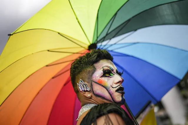 A reveler takes part in the Gay Pride march in Caracas, Venezuela, Sunday, July 2, 2023. (Photo by Matias Delacroix/AP Photo)