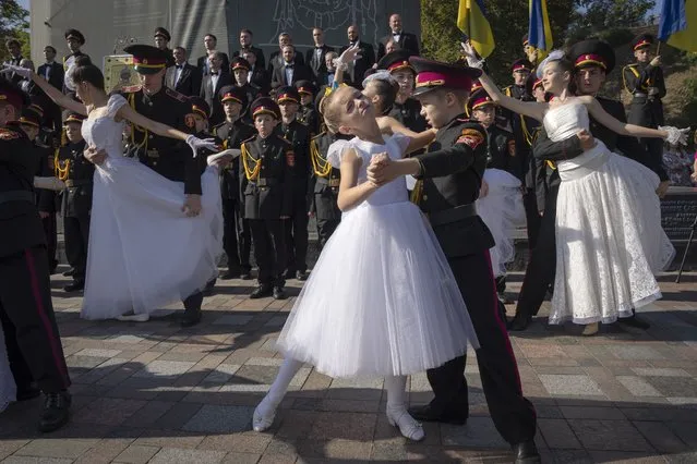 Young cadets and schoolgirls dance to mark a swear-in ceremony at a monument to legendary Prince Volodymyr one of the symbols of the Ukrainian capital in Kyiv, Ukraine, Friday, September 29, 2023. (Photo by Efrem Lukatsky/AP Photo)