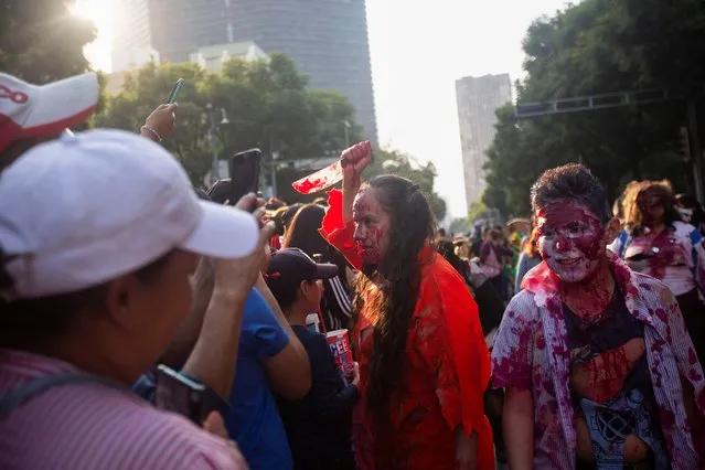 People dressed as zombies attend the annual Zombie Walk in Mexico City, Mexico on October 21, 2023. (Photo by Quetzalli Nicte-Ha/Reuters)