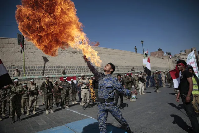 A newly recruited Shiite fighter, known as Houthi, displays his skills during a parade aimed at mobilizing more fighters into battlefronts to fight pro-government forces in several Yemeni cities, in Sanaa, Yemen, Thursday, January 5, 2017. (Photo by Hani Mohammed/AP Photo)