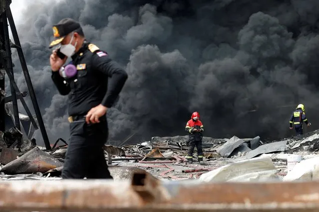A firefighter participates in efforts to extinguish a plastic factory after an explosion in Samut Prakan, outside Bangkok, Thailand on July 5, 2021. (Photo by Soe Zeya Tun/Reuters)