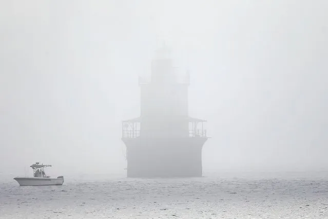 A boat passes in front of the Butler Flats lighthouse on a foggy morning in New Bedford on October 6, 202. (Photo by Peter Pereira/The Standard-Times via USA TODAY NETWORK)