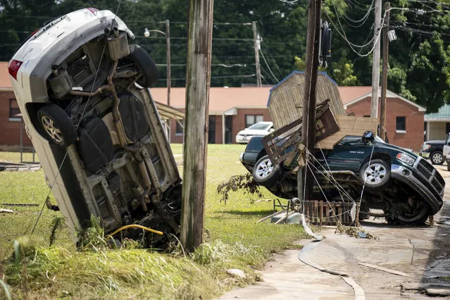 Damaged vehicles are left as a result of severe weather in Waverly, Tenn., Sunday, August 22, 2021. The downpours rapidly turned the creeks that run behind backyards and through downtown Waverly into raging rapids. (Photo by Andrew Nelles/The Tennessean via AP Photo)