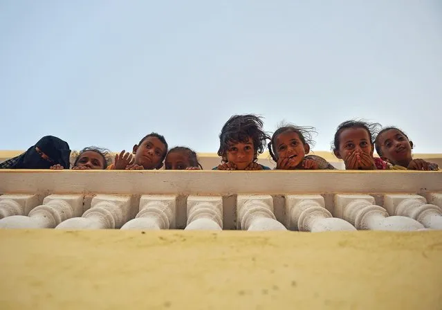 Yemeni refugee children stand on April 12, 2015 at a boarding fracility run by the UN High Commission for Refugees in Obock, a small port in Djibouti on the northern shore of the Gulf of Tadjoura, where it opens out into the Gulf of Aden. (Photo by Tony Karumba/AFP Photo)