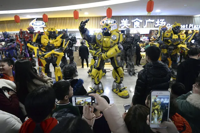 In this Thursday, February 14, 2019, photo, Transformer's character mascots entertain shoppers at a shopping mall in Handan in north China's Hebei province. U.S. and Chinese envoys are holding a second day of trade talks after the top economic adviser to President Donald Trump said he has yet to decide whether to go ahead with a March 2 tariff increase on imports from China. (Photo by Chinatopix via AP Photo)