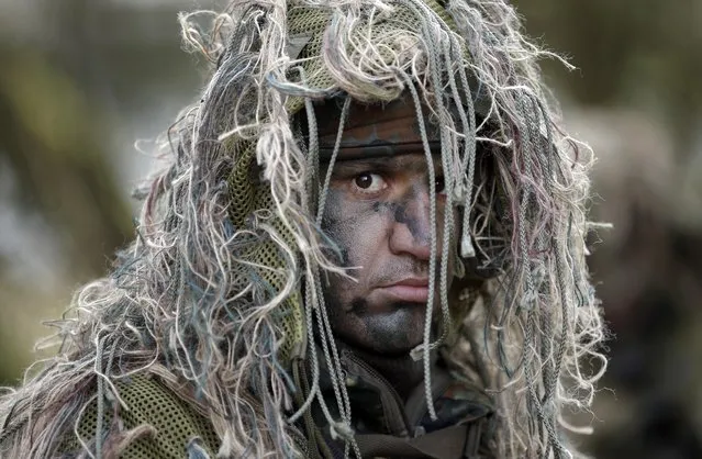 A Peshmerga fighter from Iraq takes part in a training session of the German army Bundeswehr in Munster near Hannover, Germany, Tuesday, March 1, 2016. 28 fighters of the Peshmerga are on an eleven day recon training program in Germany. (Photo by Michael Sohn/AP Photo)