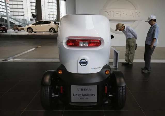 Visitors look at Nissan Motor Co's New Mobility concept car at the company's showroom in Yokohama, south of Tokyo, May 10, 2013. (Photo by Toru Hanai/Reuters)
