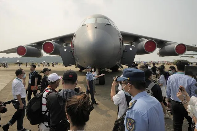 A military guide briefs invited guests on details of the Chinese People's Liberation Army (PLA) Air Force's large transport aircraft the Y-20A during 13th China International Aviation and Aerospace Exhibition, also known as Airshow China 2021, on Wednesday, September 29, 2021, in Zhuhai in southern China's Guangdong province. (Photo by Ng Han Guan/AP Photo)
