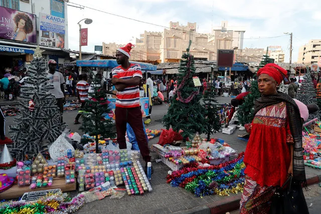 Omar Diop, 34, a street vendor sells Christmas decorations on a street in Dakar, Senegal on December 18, 2018. Picture taken December 18, 2018. (Photo by Zohra Bensemra/Reuters)