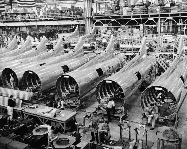 The fuselage aft sections of the latest edition of the famous Boeing Flying Fortress series the B-17E get final touches, August 2, 1942, before joining with the forward sections on the final assembly floor of the Boeing Aircraft Co. (Photo by AP Photo)