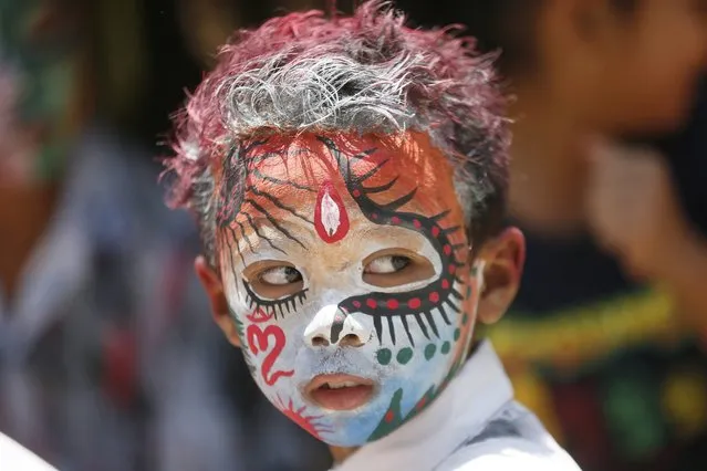 A Balinese teenager wears body paint as he takes part in the sacred Ngerebeg ritual at a village in Gianyar, Bali, Indonesia, 16 March 2016. (Photo by Made Nagi/EPA)