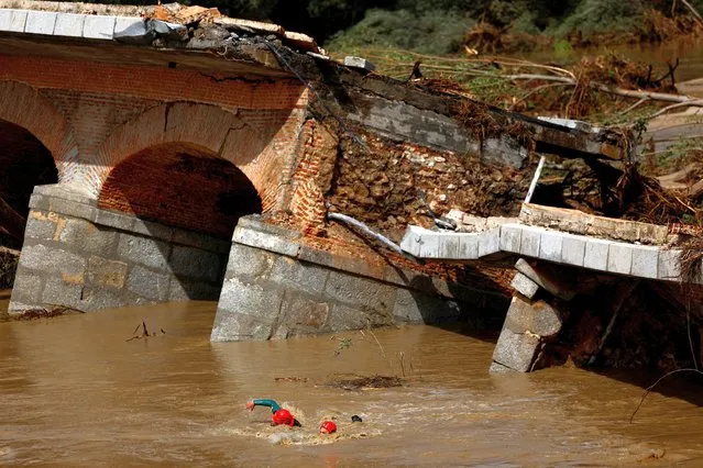 Members of the Spanish Civil Guard search and rescue team look for a missing person by a bridge that partially collapsed, following heavy rain in Aldea del Fresno, Spain on September 4, 2023. (Photo by Susana Vera/Reuters)