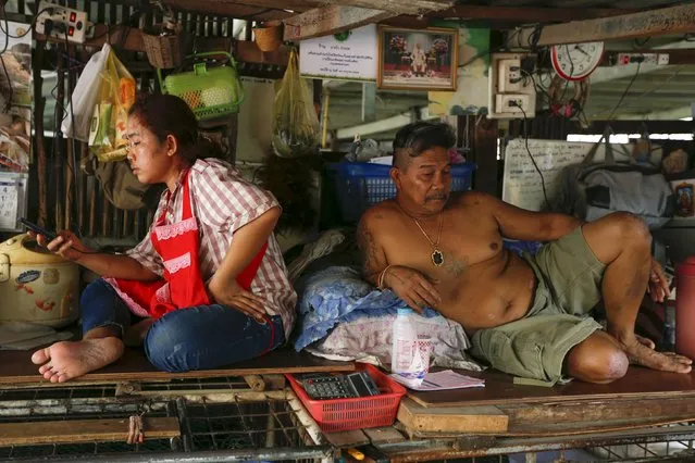 Vendors rest at their stall at a market in Bangkok, Thailand March 31, 2016. (Photo by Jorge Silva/Reuters)