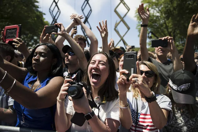Attendees cheer as Democratic presidential candidate, former Vice President Joe Biden arrives at a campaign rally at Eakins Oval in Philadelphia, Saturday, May 18, 2019. (Photo by Matt Rourke/AP Photo)