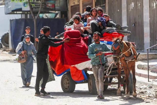 Palestinians leave with their belongings on a horse-cart along a street in Nuseirat, central Gaza, on April 12, 2024, amid ongoing battles between Israel and the Palestinian militant group Hamas. (Photo by AFP Photo)