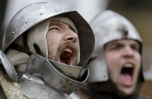 Participant wearing medieval costumes react during an annual re-enactment of a battle near the village of Libusin, Czech Republic, April 23, 2016. About 2000 enthusiasts have come to simulate the medieval battle during the 24rd annual swordsmen gathering in Libusin village. (Photo by David W. Cerny/Reuters)