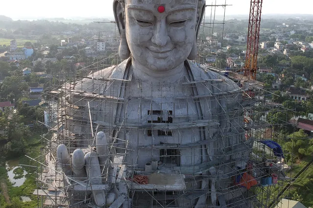 This aerial photograph shows a giant under-construction Buddha statue at Khai Nguyen pagoda in Son Tay on the outskirts of Hanoi on May 18, 2019 on the eve of Vesak day or Buddha day festival, marking the birth of Gautama Buddha, his attaining enlightenment, and his passing away. (Photo by Manan Vatsyayana/AFP Photo)