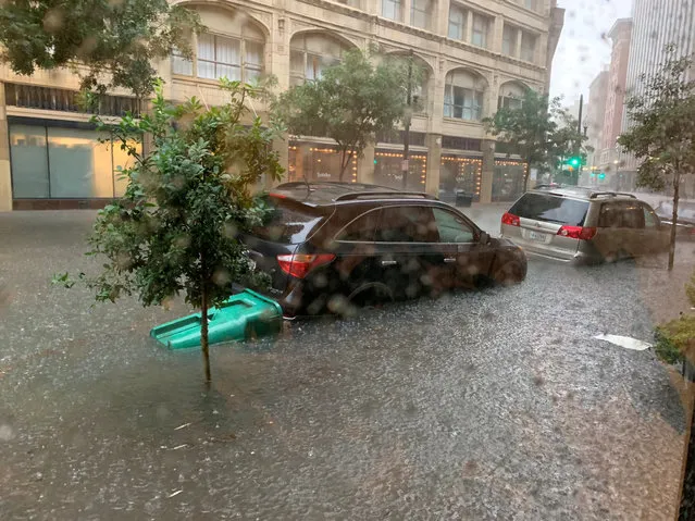 Vehicles sit in high waters after heavy rain in New Orleans, Louisiana, July 10, 2019 in this image obtained from social media. (Photo by Ellen Gerstein/Reuters)