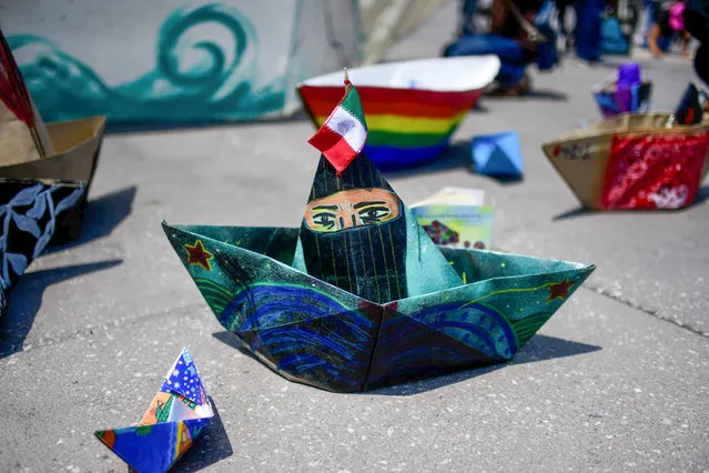 View of boats made of paper as activists take part in a cultural and informative event about the delegation of the Zapatista Army of National Liberation (EZLN) former guerrilla, which will depart on the “La Montaña” ship for Europe to meet with anti-capitalist groups in 30 different countries, at the Zocalo square, in Mexico City, on May 2, 2021. (Photo by Pedro Pardo/AFP Photo)