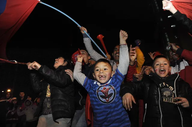 Fans of Chile's national soccer celebrate their team's victory over Peru during the Copa America semifinal soccer match, in Santiago, Chile, Monday, June 29, 2015. Chile won the match 2-1. (Photo by Victor Ruiz/AP Photo)