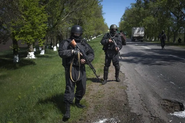 Ukrainian government troops patrol on a country road outside the town of Svyitohirsk near to Slovyansk, eastern Ukraine, Saturday, April 26, 2014. Ukrainian authorities are undertaking a security operation to liberate the nearby city of Slovyansk, which is currently controlled by an armed pro-Russian insurgency. (Photo by Alexander Zemlianichenko/AP Photo)