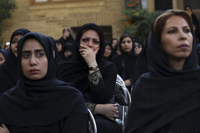 A woman weeps while watching Tazieh, a traditional play re-enacting the death of Hussein, the grandson of Prophet Muhammad and 72 of his companions, a day ahead of Ashoura, in downtown Tehran, Iran, Monday, September 9, 2019. (Photo by Vahid Salemi/AP Photo)