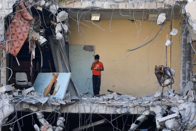 A Palestinian boy stands among rubble, after Israeli forces withdrew from a part of Gaza City, following a ground operation, amid the Israel-Hamas conflict, in Gaza City, on July 12, 2024. (Photo by Dawoud Abu Alkas/Reuters)