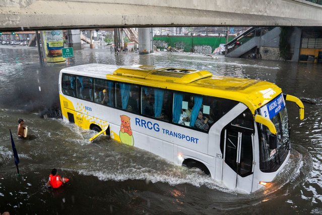 A bus wades through a flooded road following heavy rains brought by Typhoon Gaemi, in Manila, Philippines, on July 24, 2024. (Photo by Lisa Marie David/Reuters)